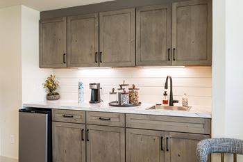 A kitchen with wooden cabinets and a marble countertop.